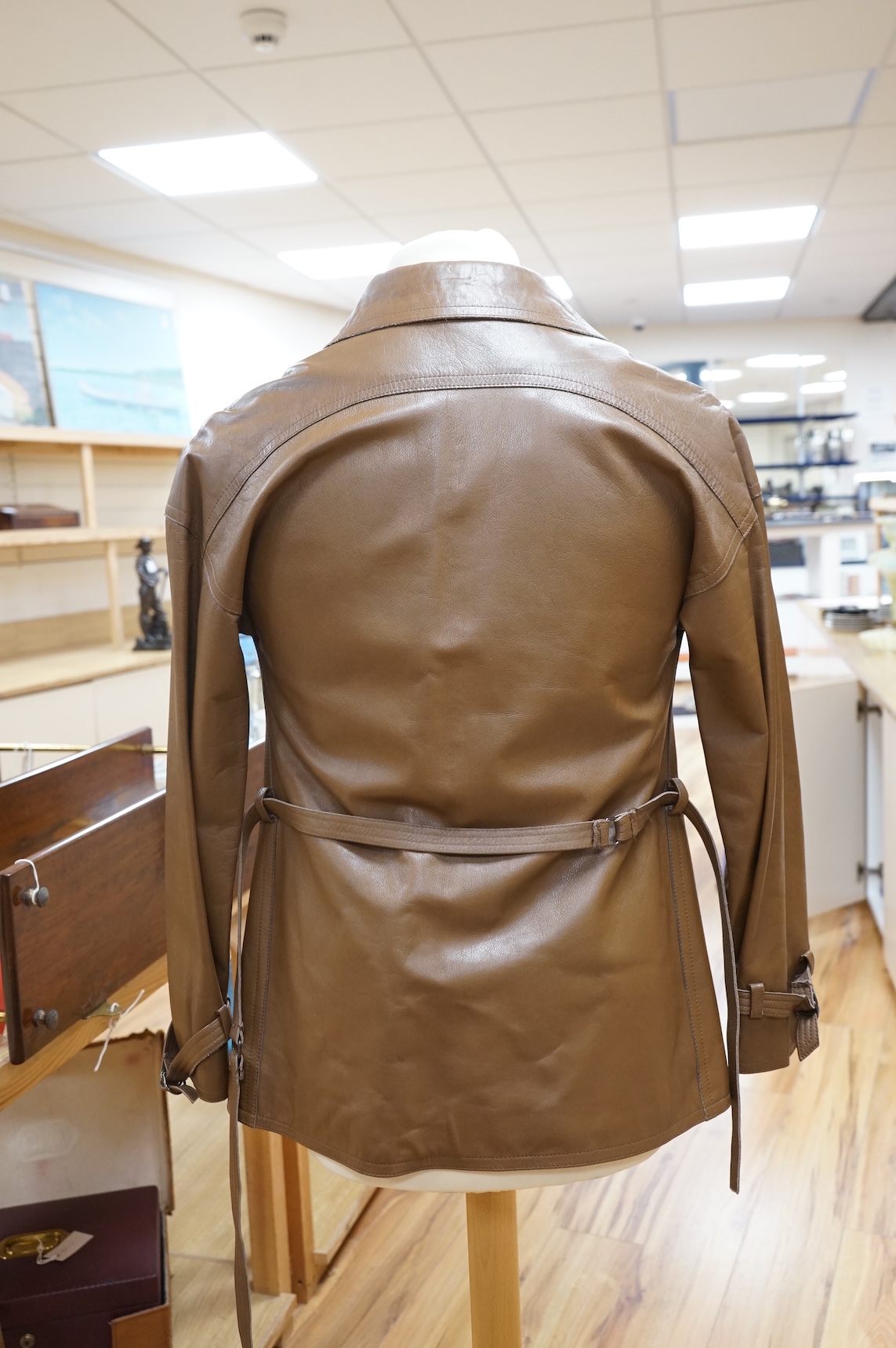A Baccarat tan leather jacket and a black close-fitting Korean leather jacket size 10